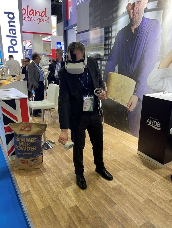 Man wearing VR headset to watch VR cheesemaking